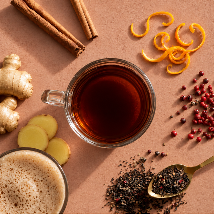 black tea on a teracotta table with spices surrounding it