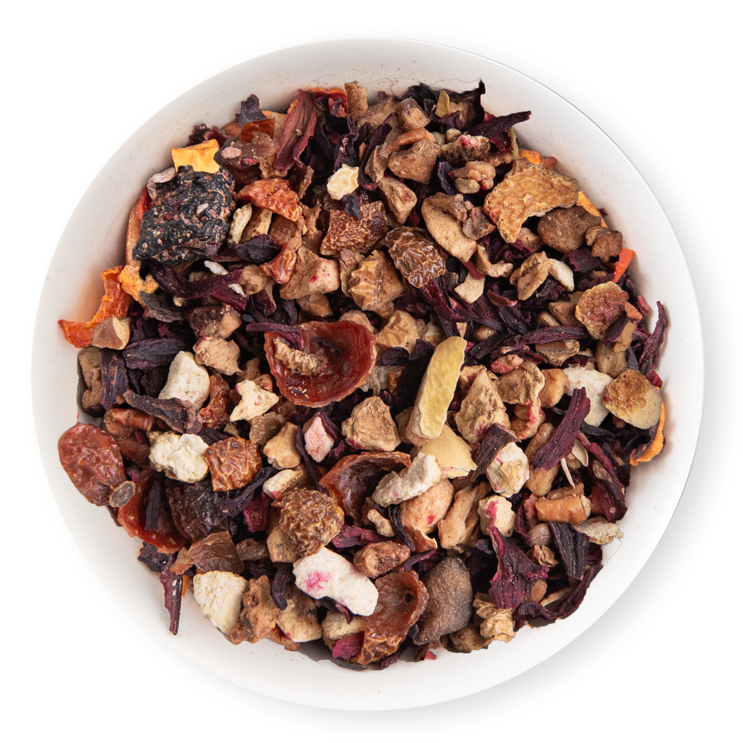 Assorted dried fruit and tea leaves in a white bowl on a white background