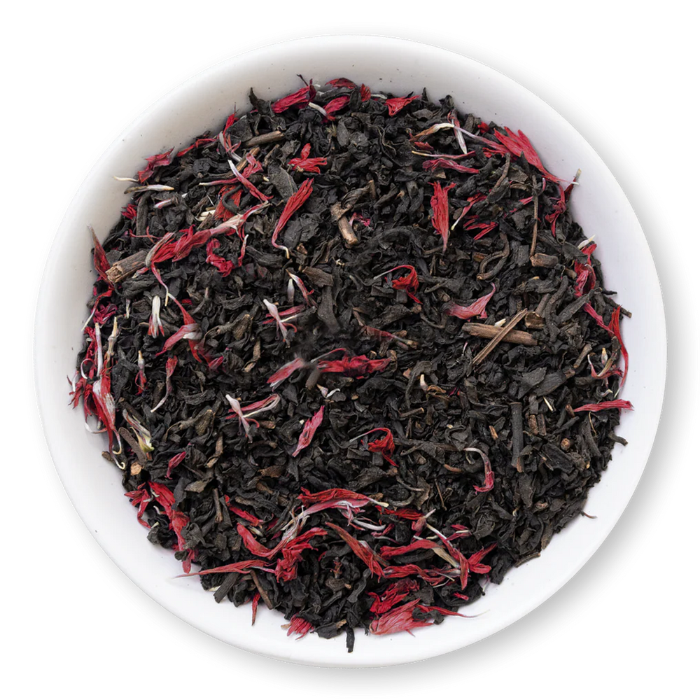 Black tea leaves with red petals in a white bowl