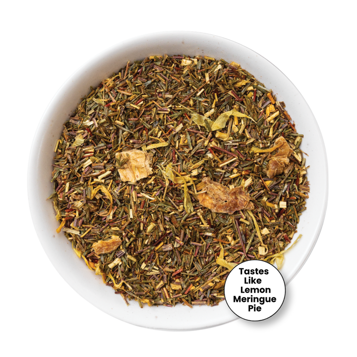 A top-down view of a loose leaf herbal tea blend in a white bowl, with a small circular badge in the lower right that reads &