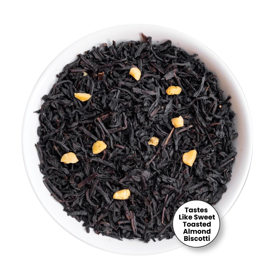 Black tea loose leaves with small toasted almond pieces, presented in a white bowl on a white background with a circular text badge.