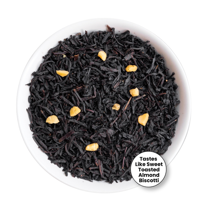 Black tea loose leaves with small toasted almond pieces, presented in a white bowl on a white background with a circular text badge.