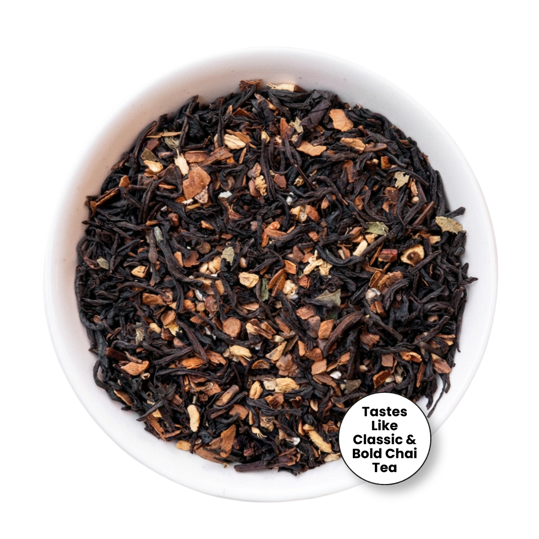 A top-down view of loose-leaf tea in a white bowl, featuring dark black tea leaves mixed with brown and beige dried fruit and flower petals. A white circular badge in the bottom right corner reads &