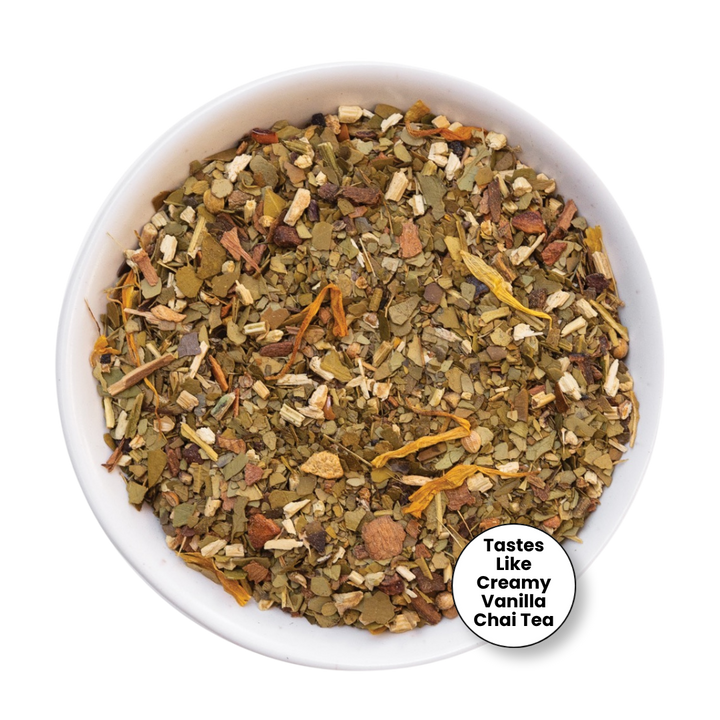 A top-down view of a white bowl filled with loose-leaf herbal tea blend, with a small white circular label in the lower right that reads &