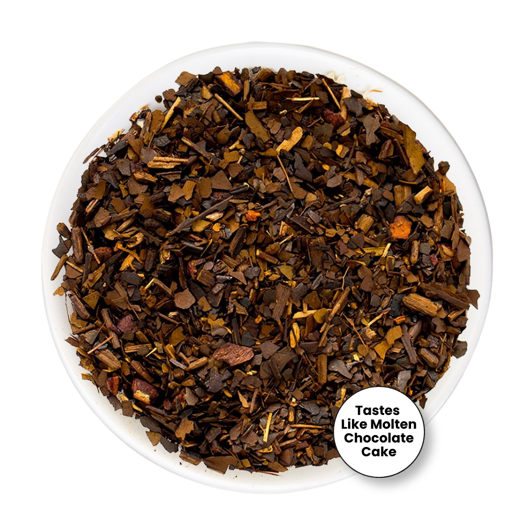A top-down view of loose-leaf tea or coffee blend in a white bowl, with a small white circular badge in the lower right that reads &