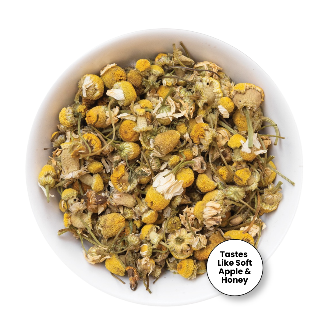Dried chamomile tea loose leaves in a white bowl, with a circular badge in the bottom right corner that reads &