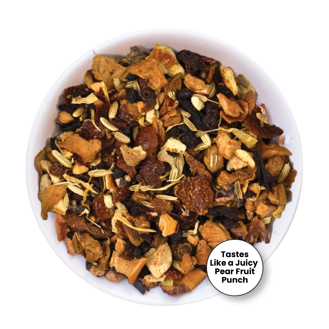 A top-down view of a white bowl filled with dried fruit and herb tea blend, featuring pieces of dried pear, apple, berries, and light tan herbal pieces. A white circular badge in the lower right reads &