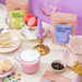 Tea and pastries setup with teacups and cookies on a table.