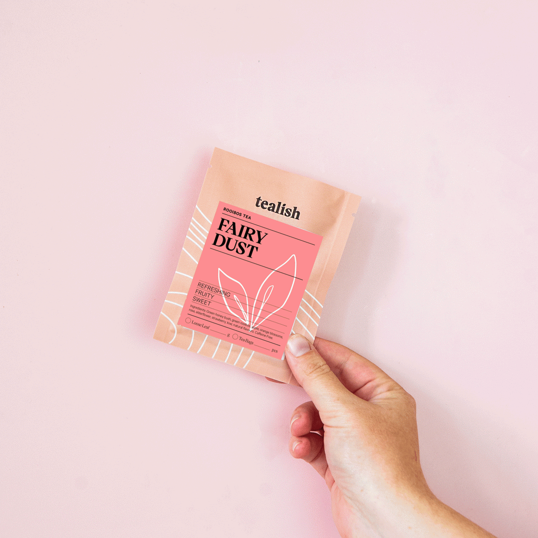 small tealish tea sample pouch with hand holding it up