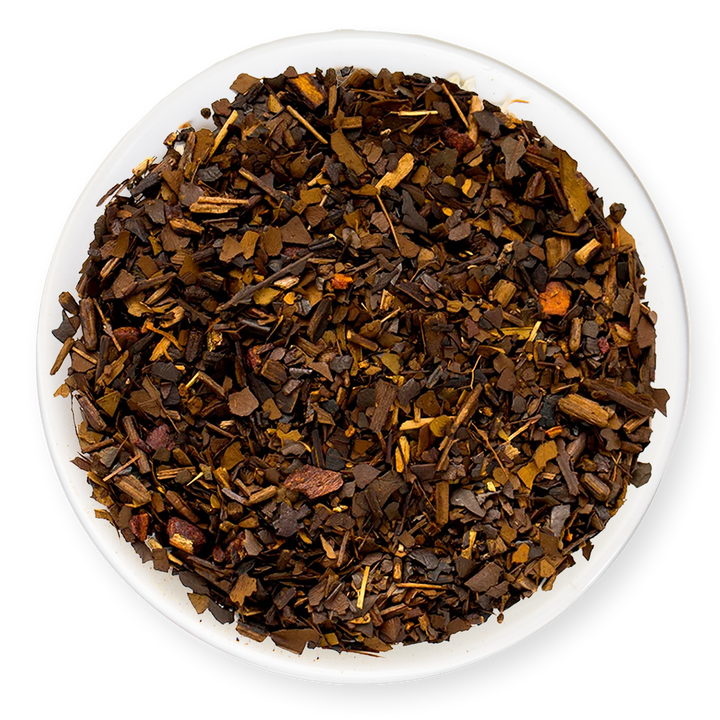 Dry tea leaves in a white bowl on a white background
