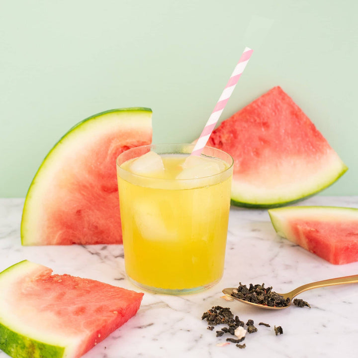 a picture of iced watermelon oolong tea with watermelons around it